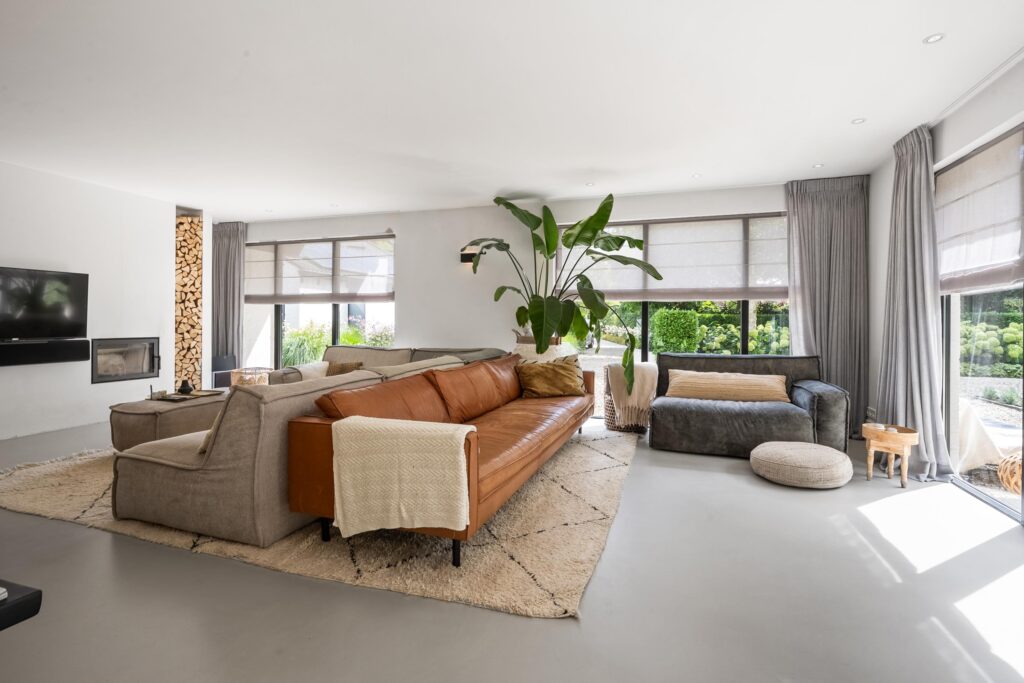Modern living room with large windows and sofas.