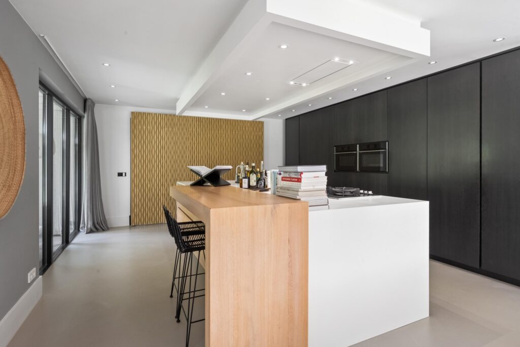 Modern kitchen with wood island and appliances.
