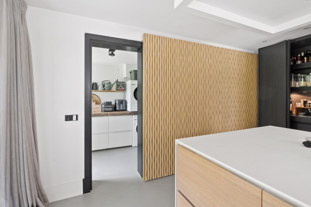 Modern kitchen with sliding door to laundry room.
