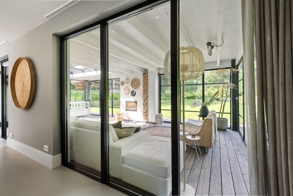 Modern living room with large glass doors.