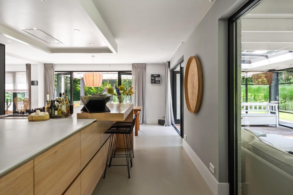 Modern kitchen with wooden cabinets and open patio view