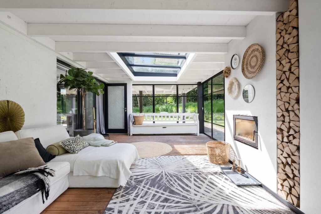 Modern living room with skylight and fireplace.