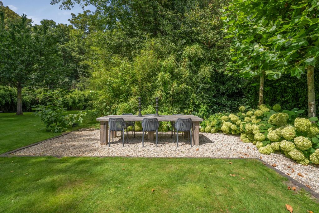 Outdoor dining area with wooden table and chairs.