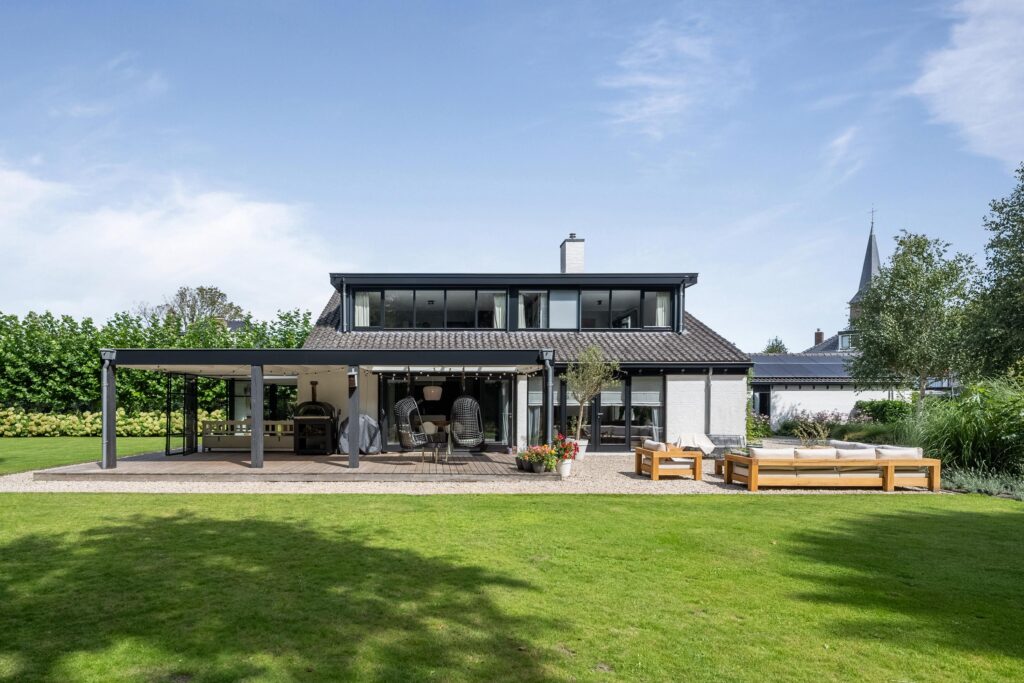 Modern backyard with patio furniture and garden view.