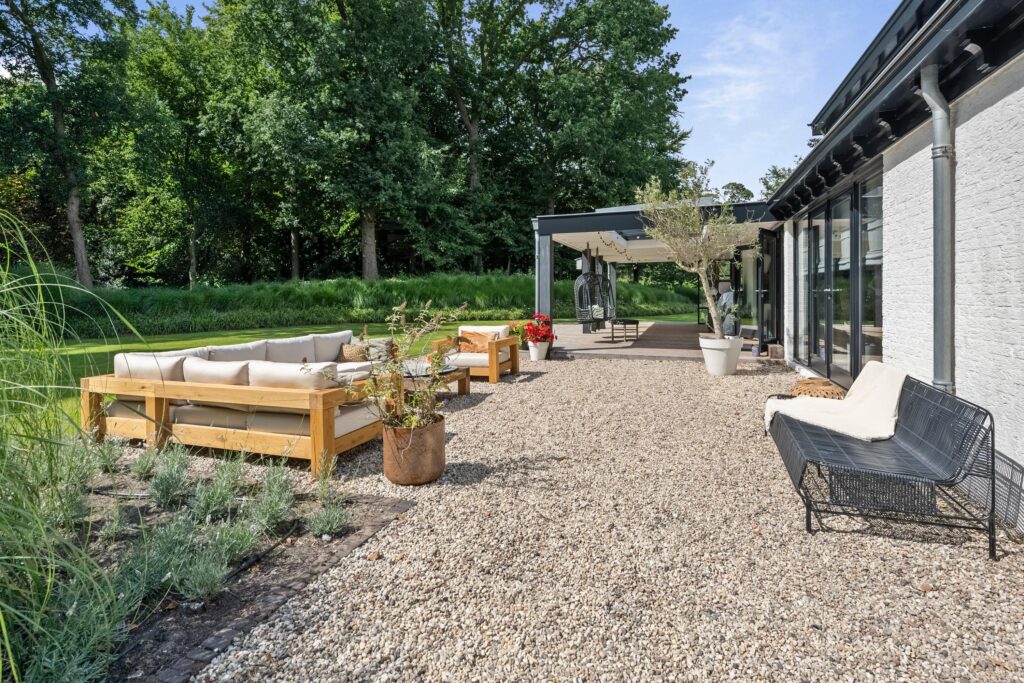 Modern patio with outdoor seating and garden view.