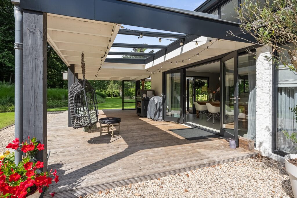 Modern patio with glass doors and garden view.