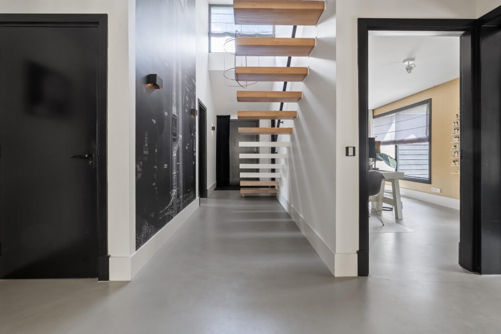 Modern hallway with floating wooden staircase