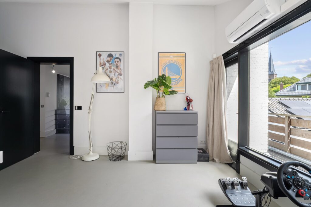 Modern room with gaming setup and decor posters.