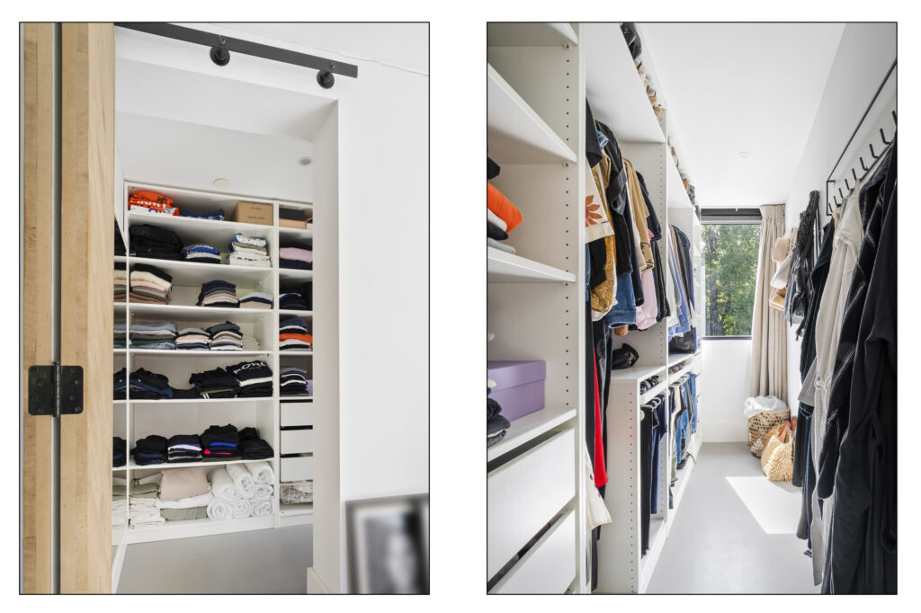 Organized walk-in closet with shelves and hanging clothes.
