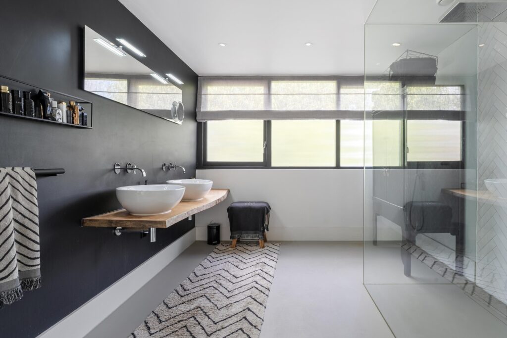 Modern bathroom with dual sinks and glass shower