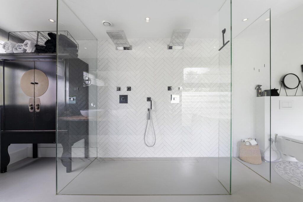 Modern bathroom with glass shower and white tiles