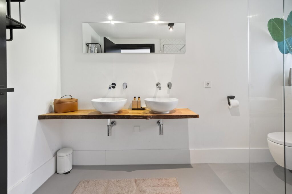 Modern bathroom with double sinks and large mirror.