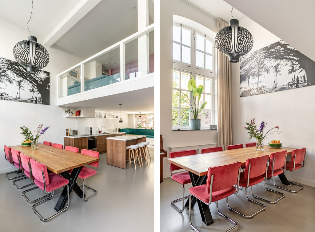 Modern dining area with red chairs and kitchen island.