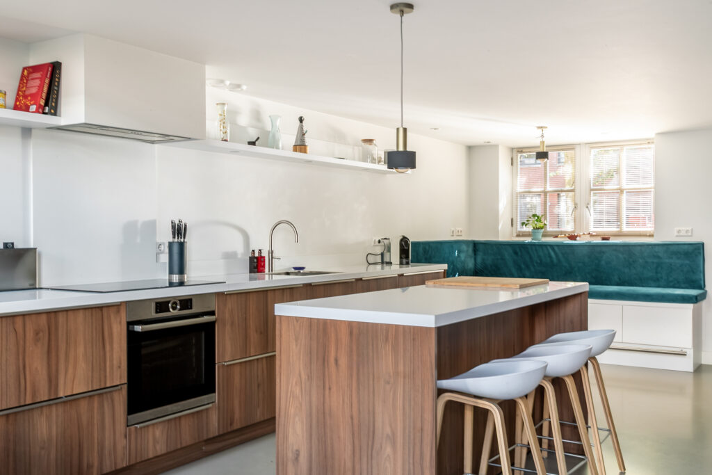Modern kitchen with island and wooden cabinets.