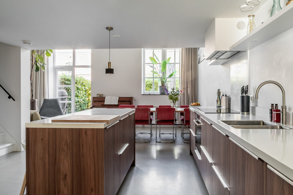 Modern kitchen with island and dining area.