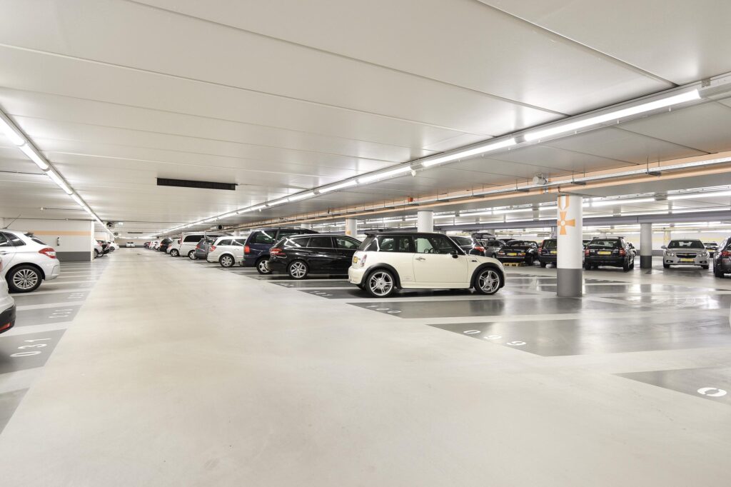 Underground parking lot with cars parked in rows.
