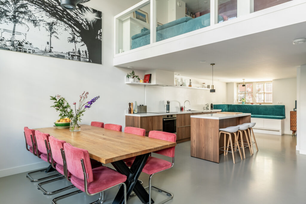 Modern kitchen with dining area and contemporary decor.