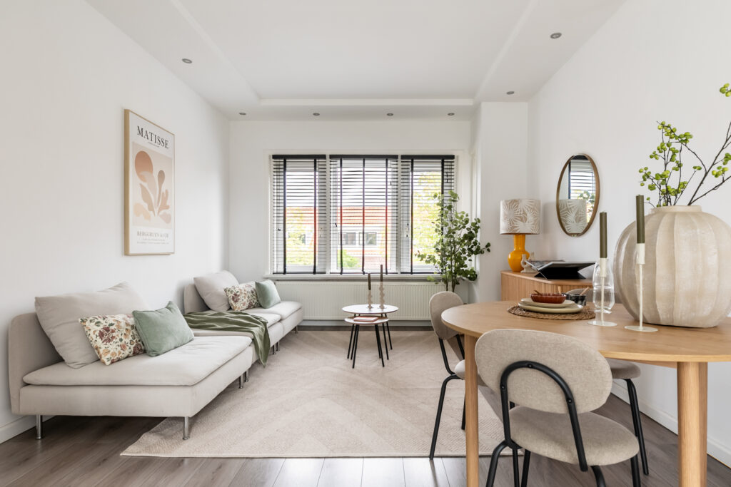 Modern living room with white decor and windows.