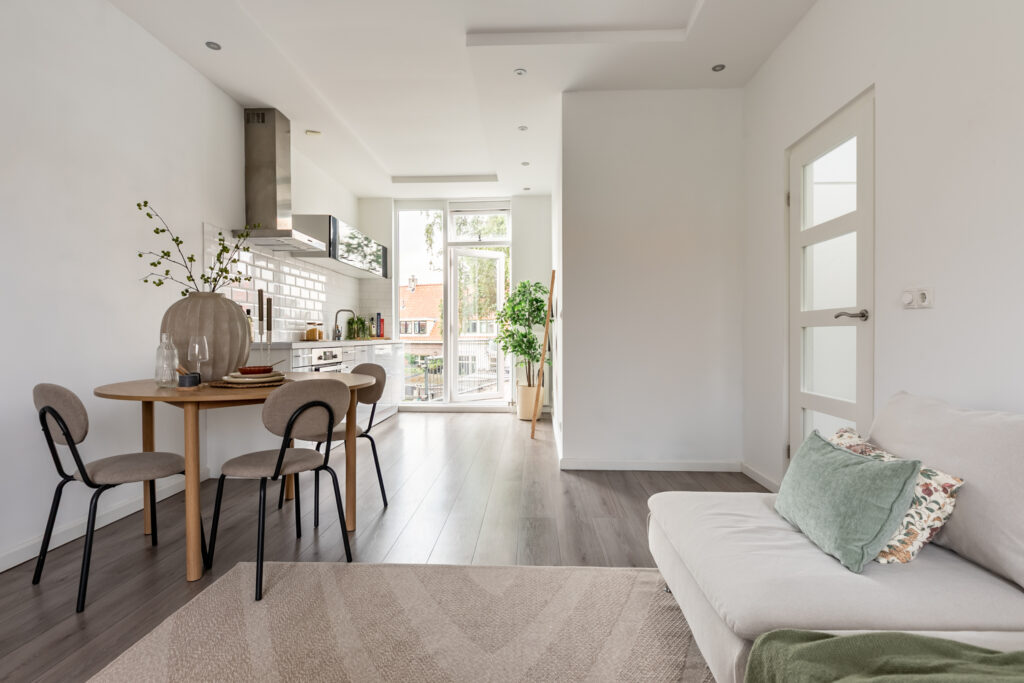 Bright modern kitchen with dining table and sofa