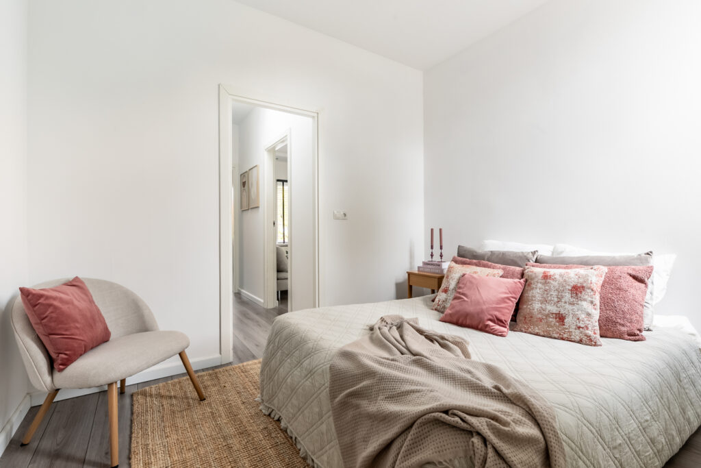 Cozy bedroom with pillows and chair