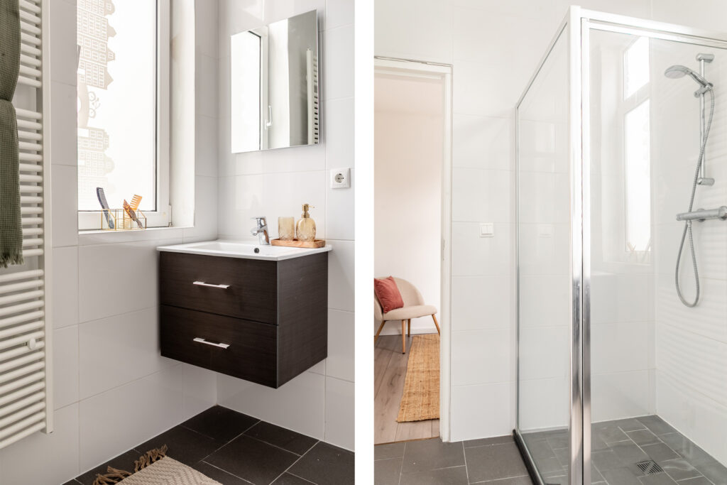 Modern bathroom with sink and glass shower.