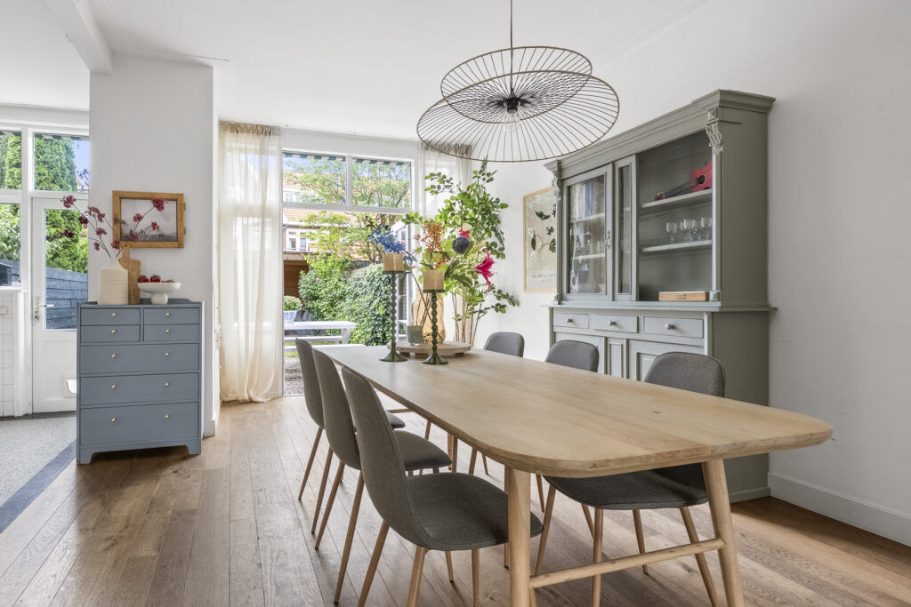 Elegant dining room with wooden table and chairs.