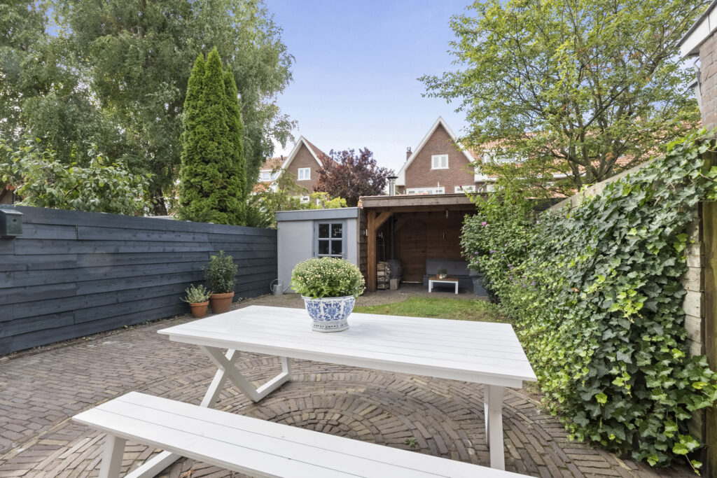 Cozy backyard with picnic table and garden shed.