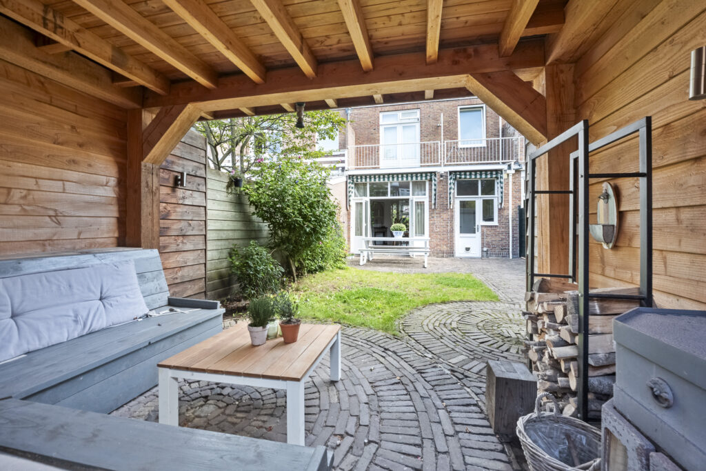 Cozy backyard with patio seating and green lawn.