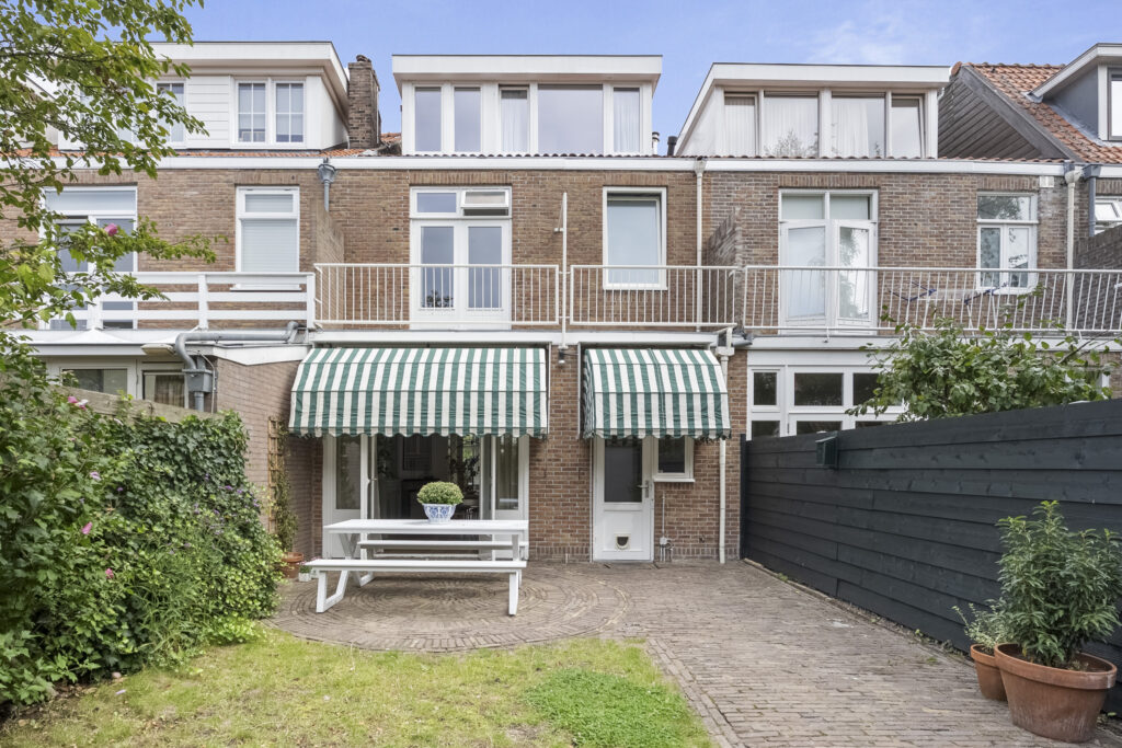 Two-story brick house with striped awnings