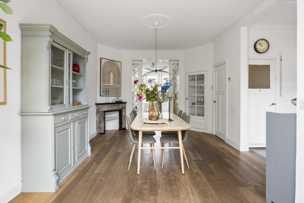 Elegant dining room with wooden floors and decor.