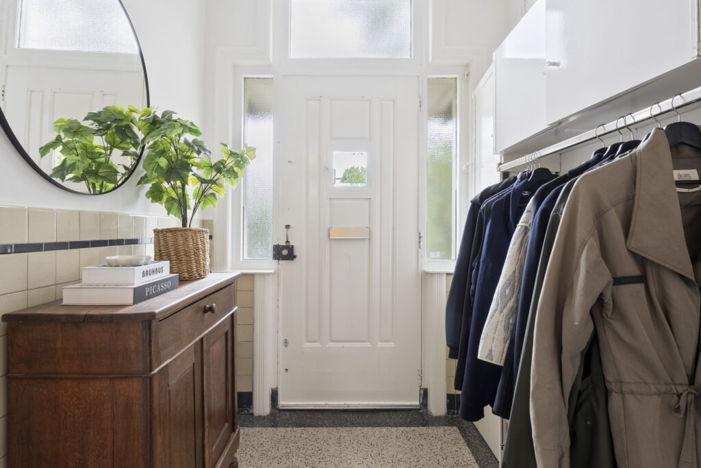 Modern entryway with coat rack and wooden cabinet