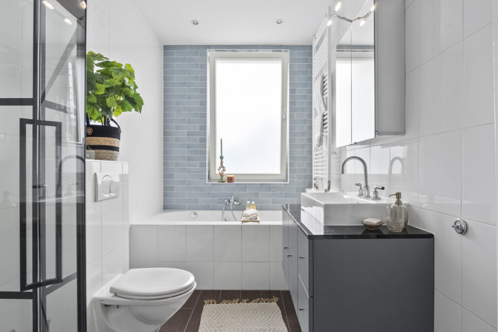 Modern bathroom with plants and large window
