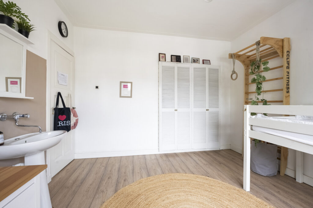Minimalist bedroom with climbing wall and plants