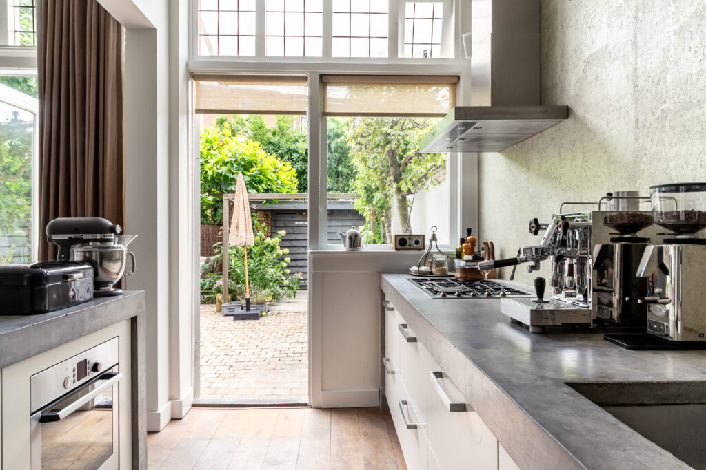 Modern kitchen with garden view through open door