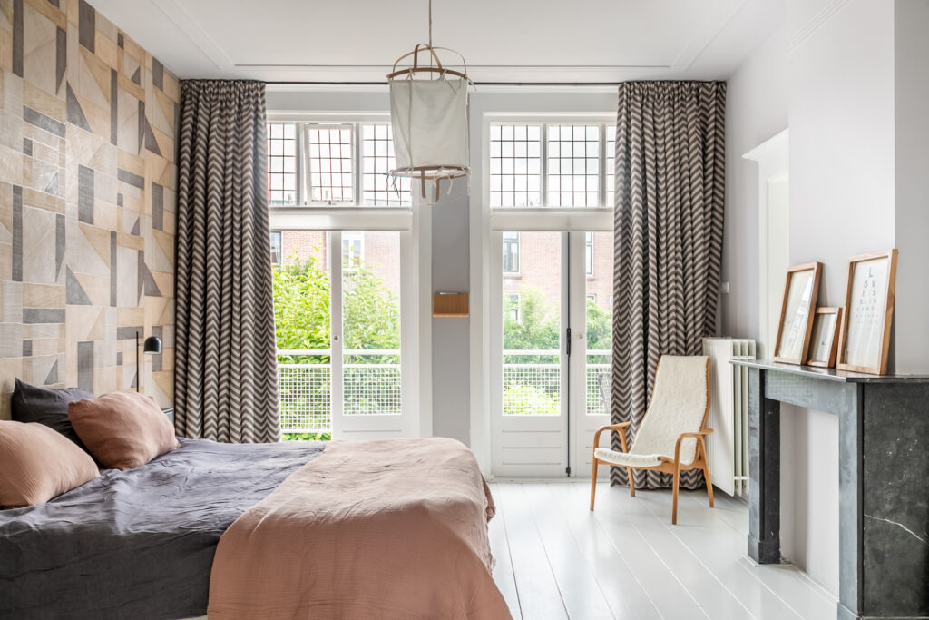Contemporary bedroom with large windows and modern decor.