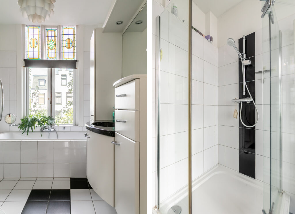 Modern bathroom with shower and stained glass window.