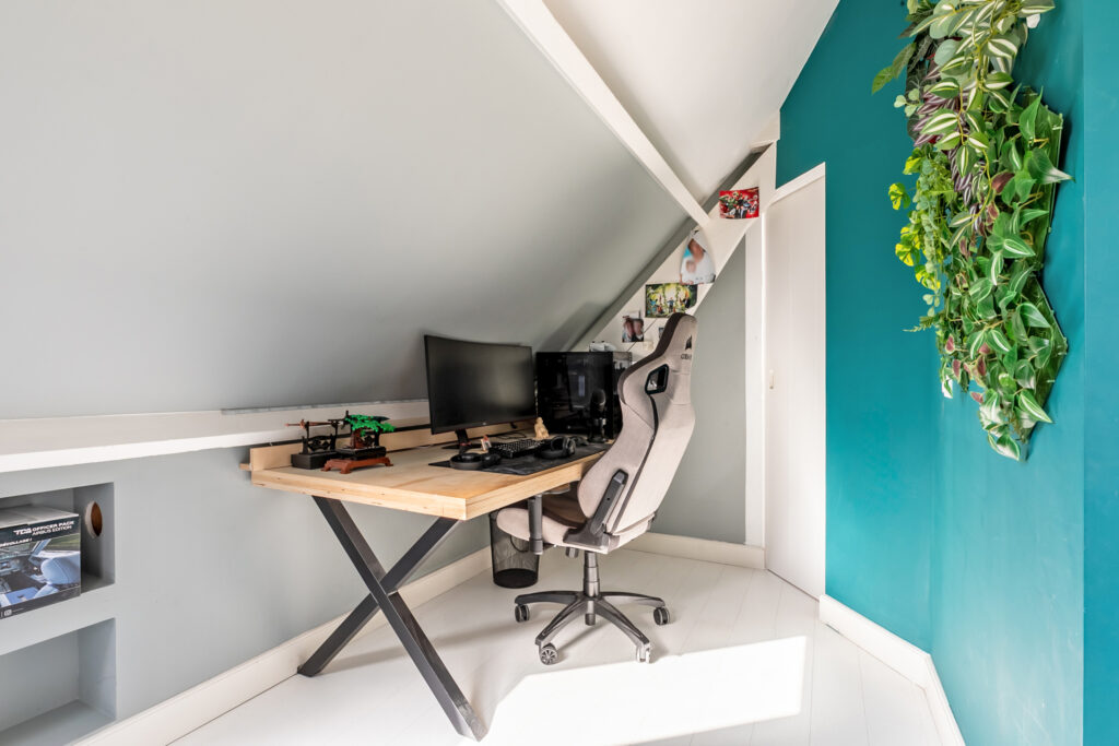 Cozy attic workspace with modern desk and chair.