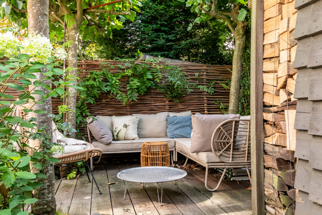 Cozy outdoor seating area with wooden furniture.