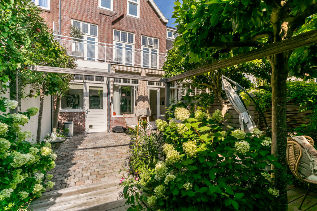 Charming garden courtyard with flowering plants and seating.