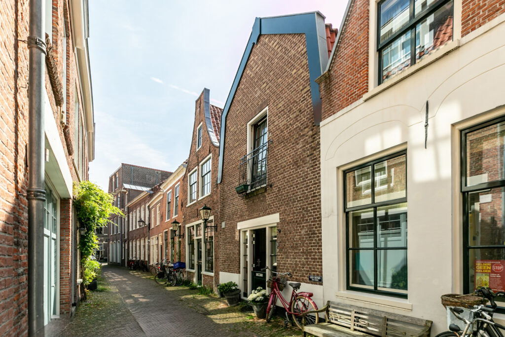 Quiet European street with bicycles and brick buildings.