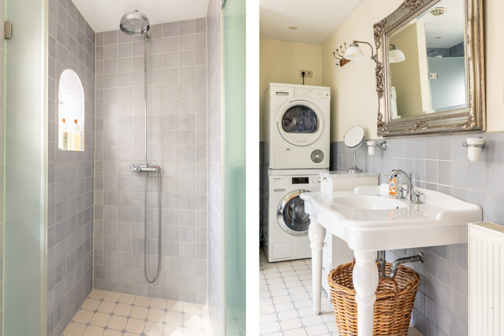 Modern bathroom with shower and laundry appliances.