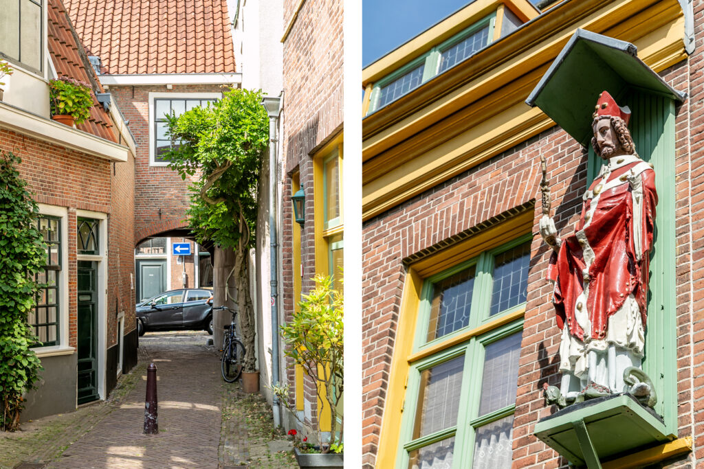 Narrow alleyway and statue in historic European town.