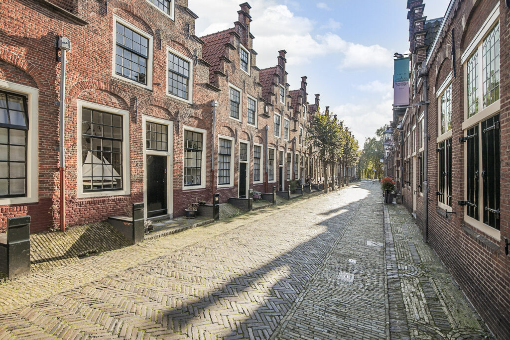 Historic cobblestone street with brick buildings.
