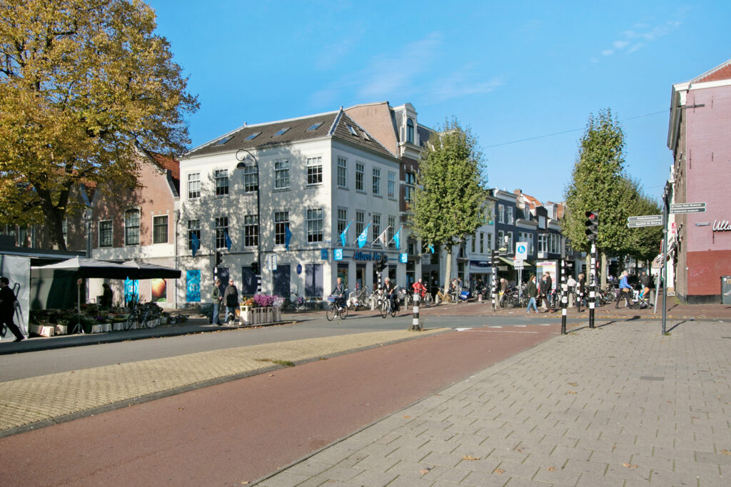 Urban street scene with cyclists and shops.