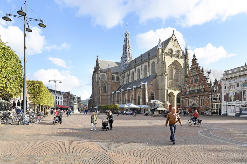 Historic town square with church and people walking