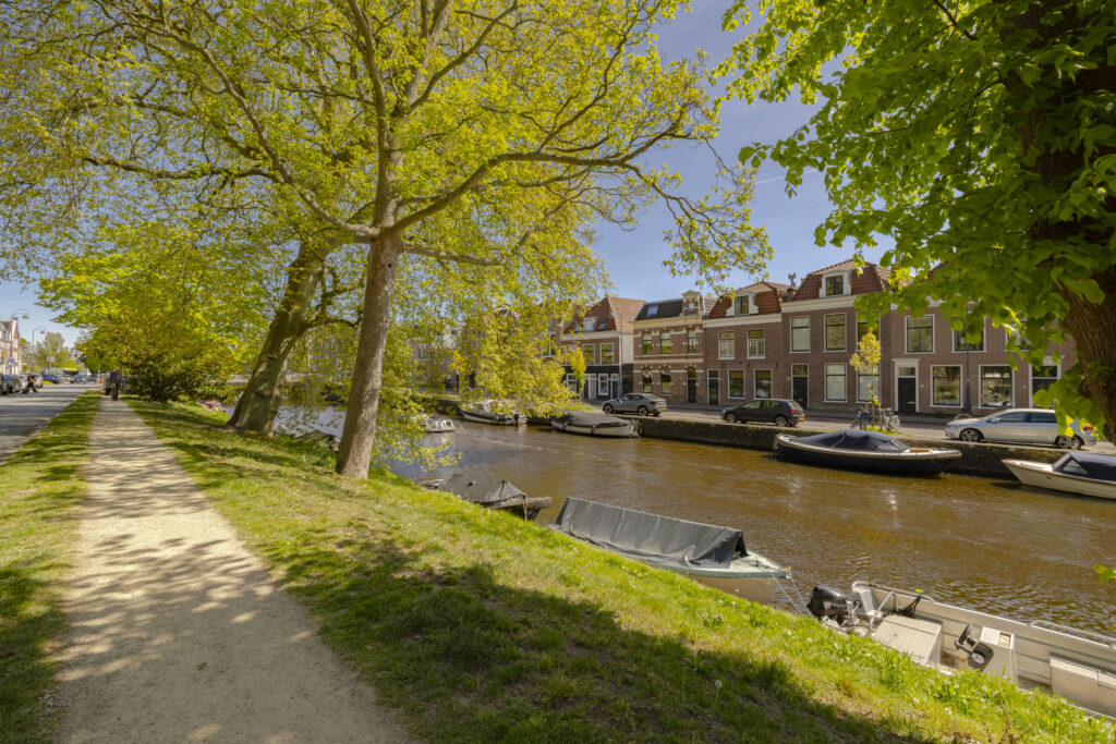 Scenic riverside pathway with boats and trees