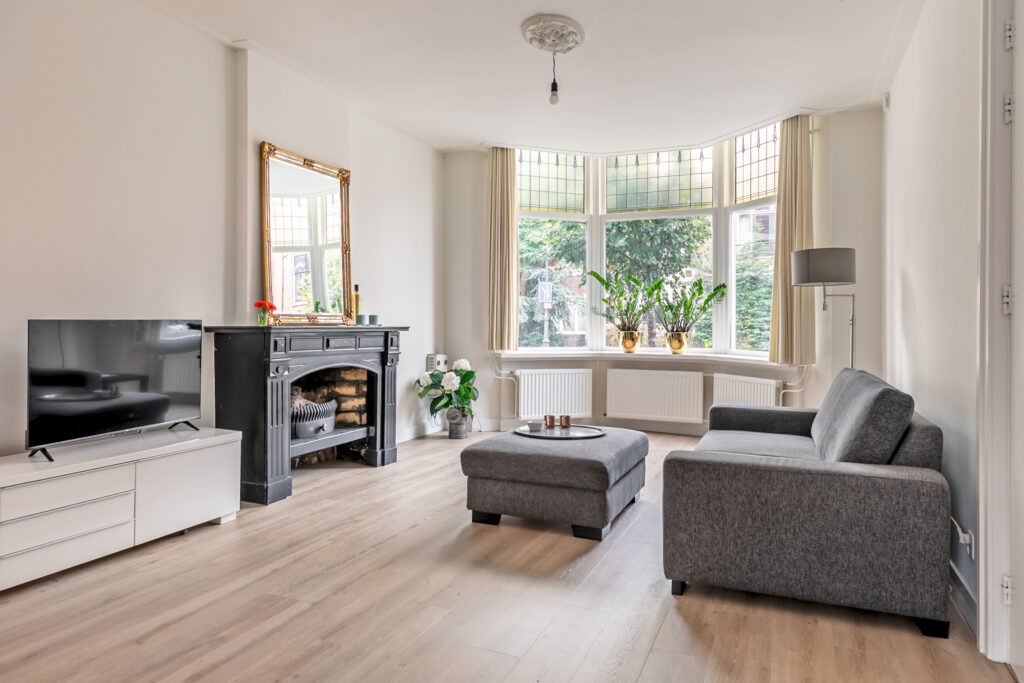 Spacious living room with modern decor and fireplace.