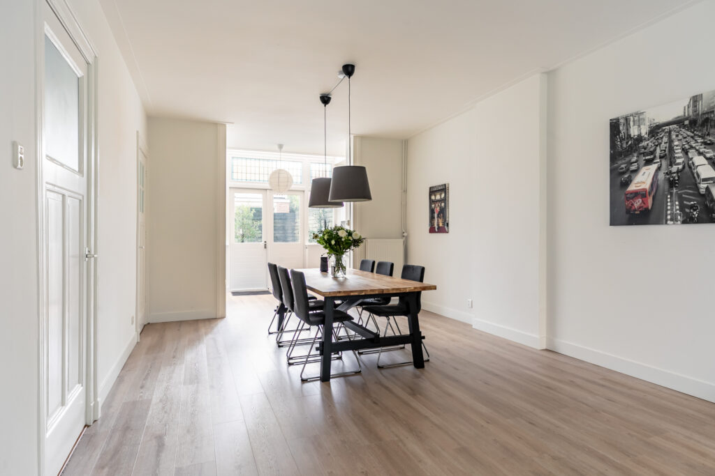 Modern dining room with wooden table and chairs.