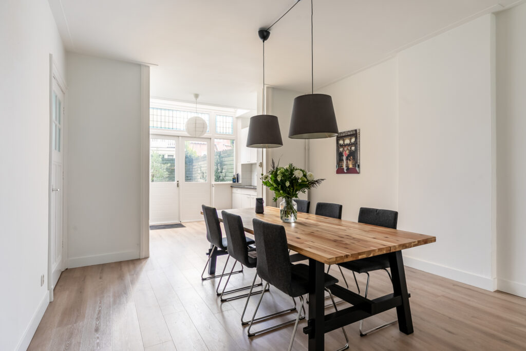 Modern dining room with wooden table and chairs.