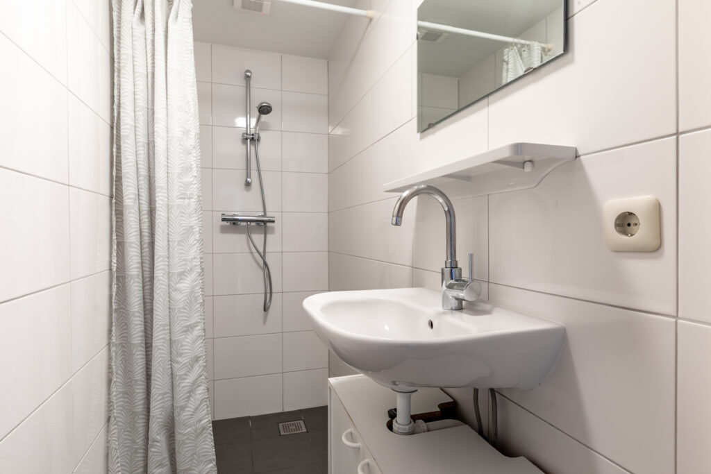 Modern bathroom with shower and sink.